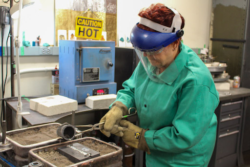 A teacher pours liquid Frankensteel into a mold.