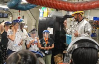 students in lab with teacher in lecture