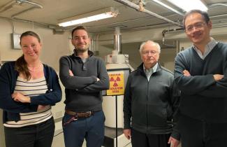 woman and 3 men standing in lab