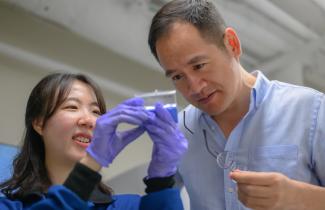 Professor Ju Li (right) and postdoc So Yeon Kim (left) examine samples of the composite they have fabricated for their demonstrations.