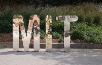 Letters MIT in a reflective mirror