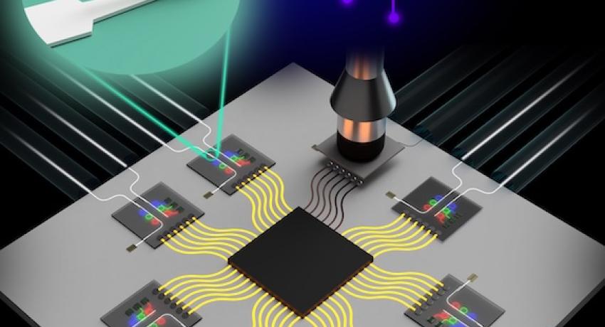 computer chip with yellow wires and tweezers